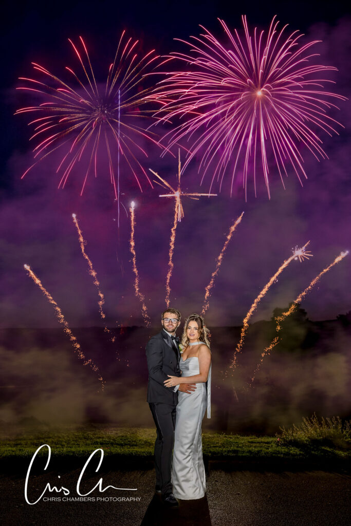 Fireworks at a wedding. Hazlewood castle wedding photography with Fireworks as the bride and groom stand with their firework display