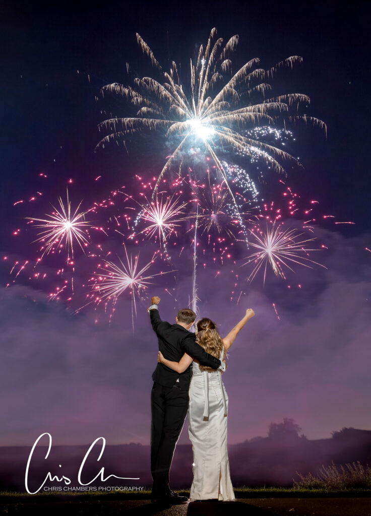 Fireworks at a wedding. Hazlewood castle wedding photography with Fireworks as the bride and groom stand with their firework display