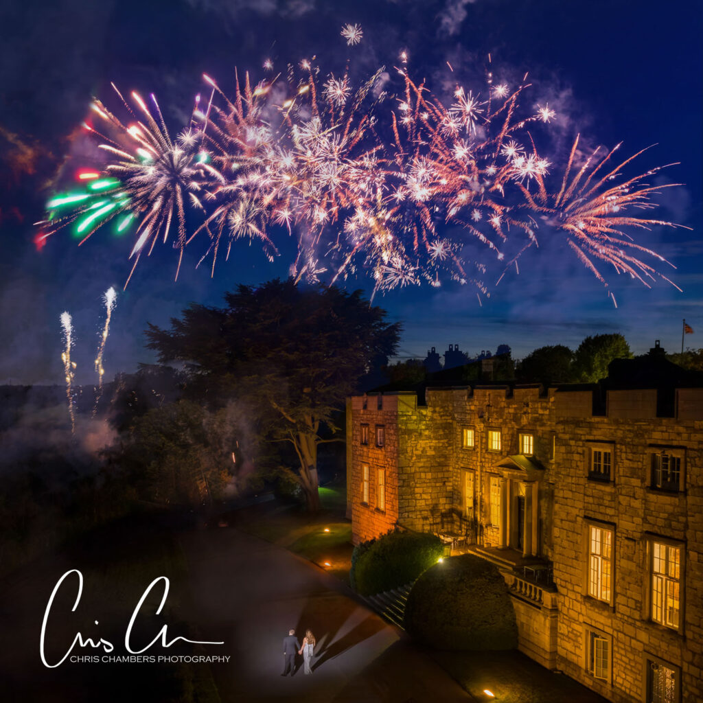 Fireworks at a wedding. Hazlewood castle wedding photography with Fireworks as the bride and groom stand with their firework display