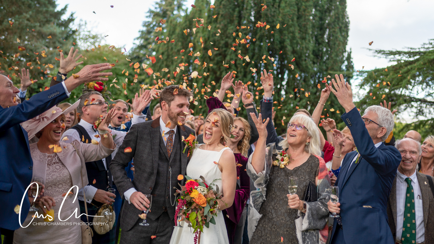 Bride and groom and their wedding guests at the Parsonage at Escrick. Confetti in the grounds